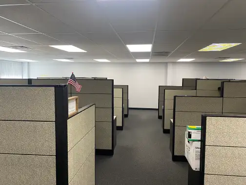 Office furniture removal crew removing desks and chairs
